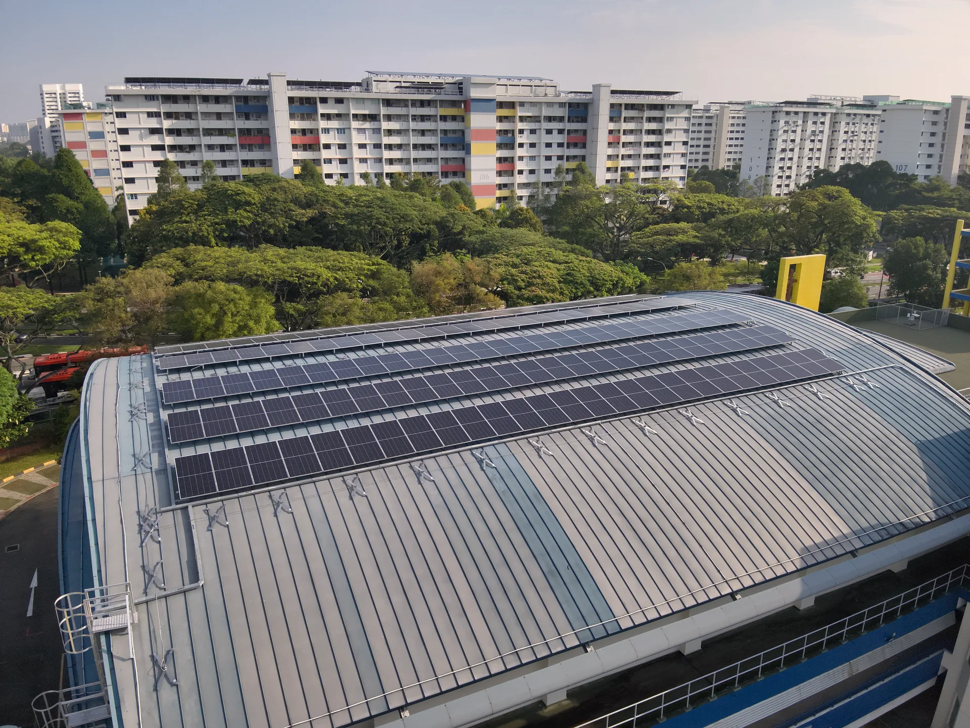 Education solar — Geylang Methodist Secondary School curved PV-clad roof in Singapore residential precinct